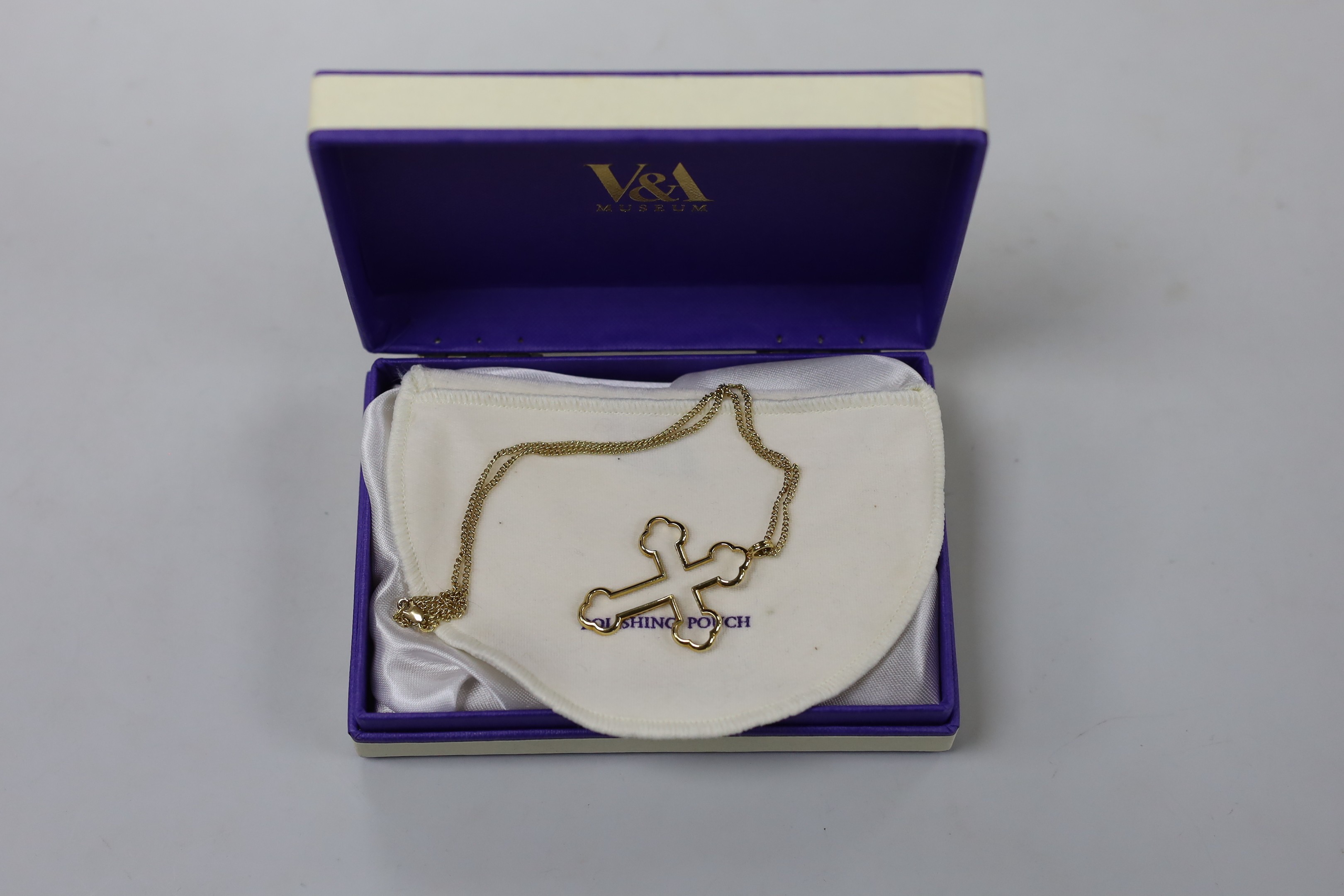 A modern 18ct gold Advalorem(for the V&A Museum in London) cross pendant, influenced by the designs of Pugin,46mm, on an 18ct gold chain, 39cm, 8.4 grams.
